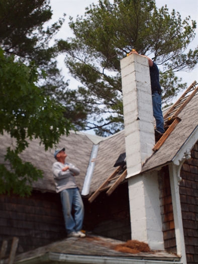 Neighbors help us put on a chimney cap to keep future Goldilocks away.