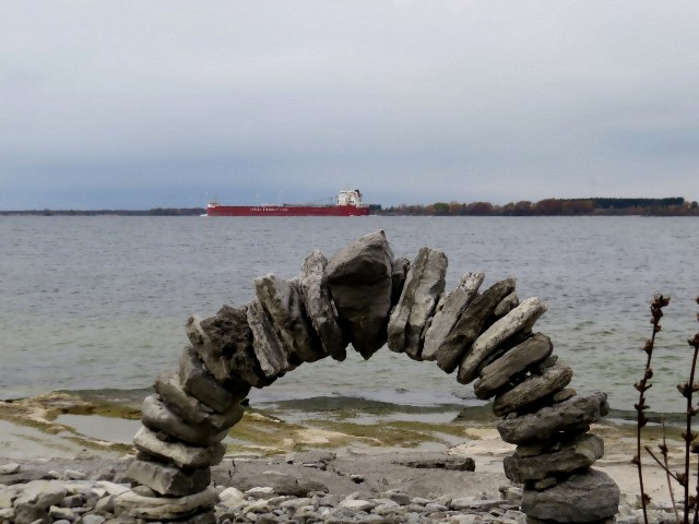 Stone arch with freighter Whitefish Bay off Tibbetts Point by Kathi McCarthy