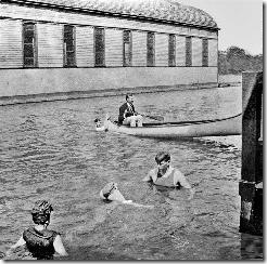Swimming off the dock of the Remington boat house (right) with the Cornell yacht house beyond. 