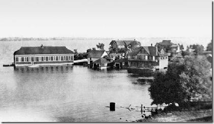 South Bay accommodated yacht, boat, and skiff houses. The Wyckoffs had two yachts, the Ezra Cornell and the Remington. The large building at left housed the Cornell. The boat house for the Remington is hidden behind, only a bit of its roof showing. The larger building to the right was a Wyckoff skiff house with quarters on second and third floors. 